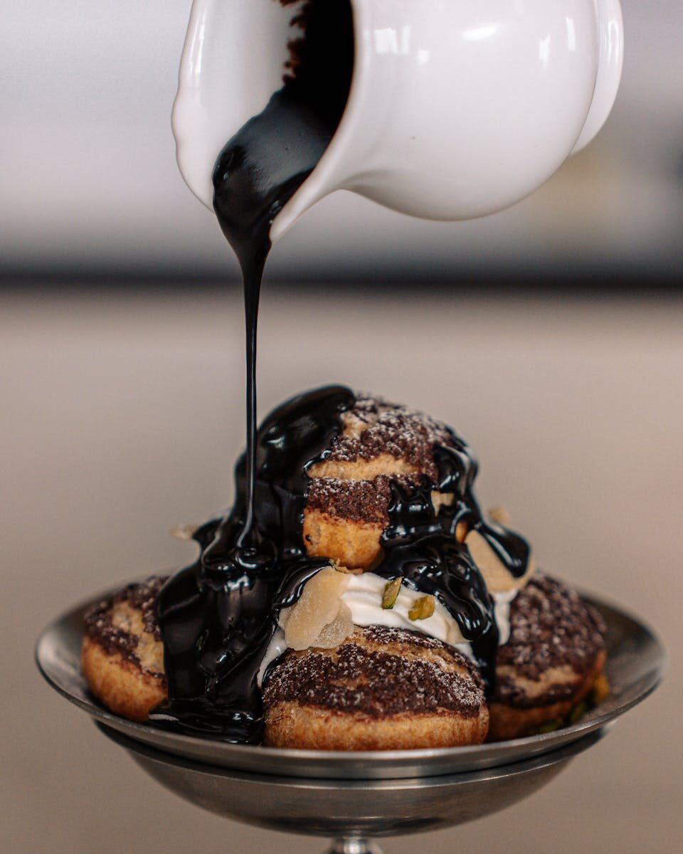 Delicious Japanese pastry drenched in rich chocolate sauce, photographed in a Tokyo café.